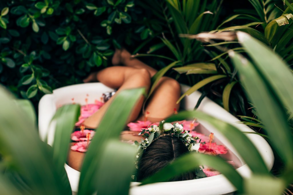 pregnant woman relaxing in a floral maternity milk bath 